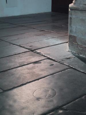 500 years of feet scraping over these crypt stones have worn off the inscriptions. Only faint numbers permit identification of the vaults occupants.