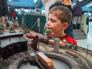 A young visitor wonders where the heck the trains are heading!  East or West? 