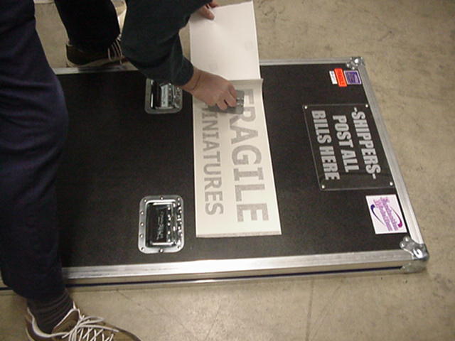 Applying the signs to the shipping case door!
