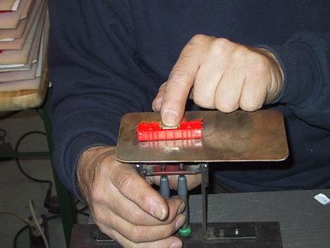 Using the jig to tighten screws on the Cleaner car